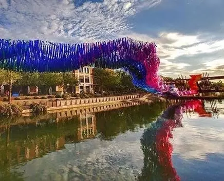 A public art installation called Reflection Rising floating over the canals in Scottsdale AZ by artist Patrick Shearn of Poetic Kinetics.